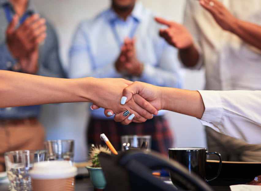 Professionals shaking hands after a successful conversation